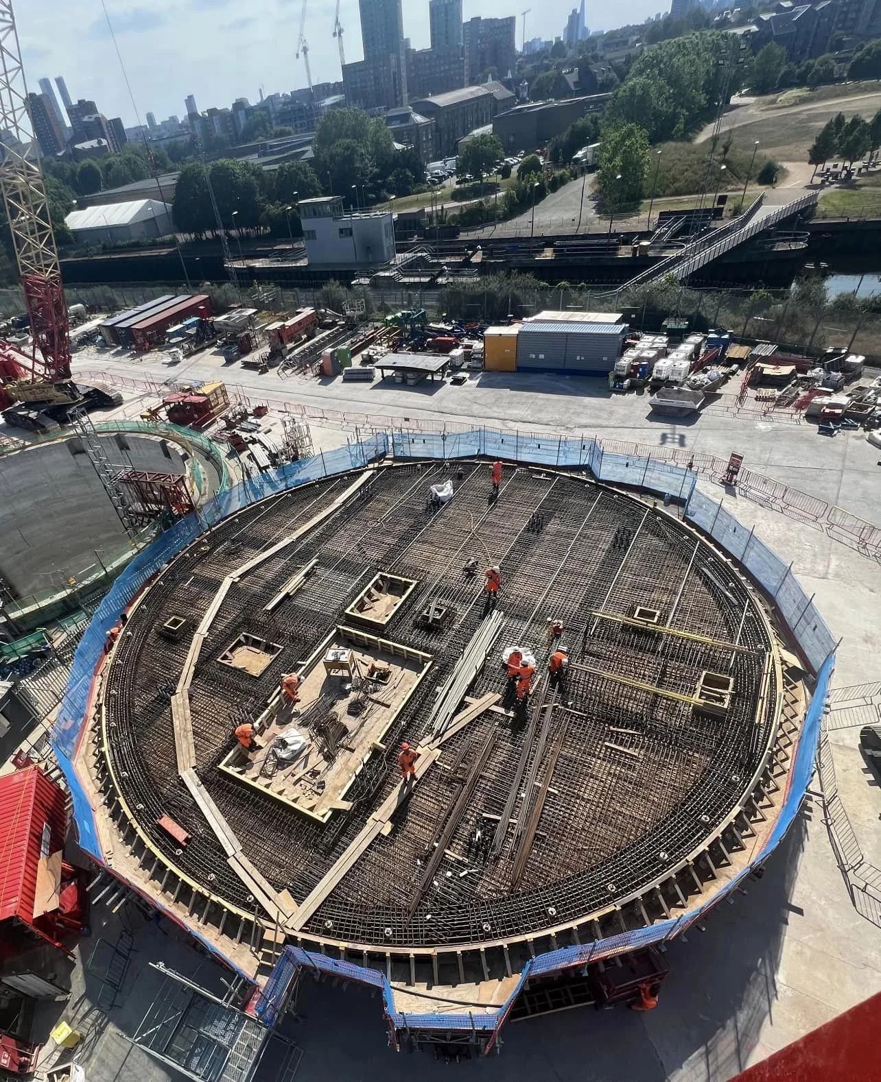 Steel fixers laying reinforcement across a circular slab at Abbey Mills